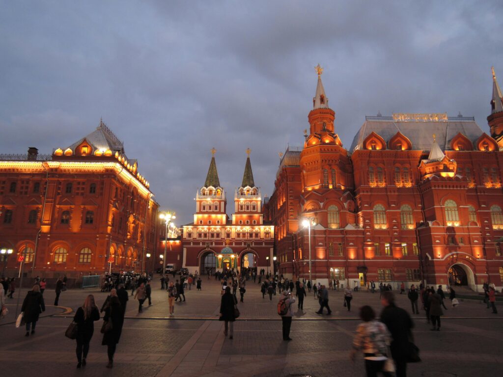 Beautiful evening view of Red Square in Moscow with a lively crowd.